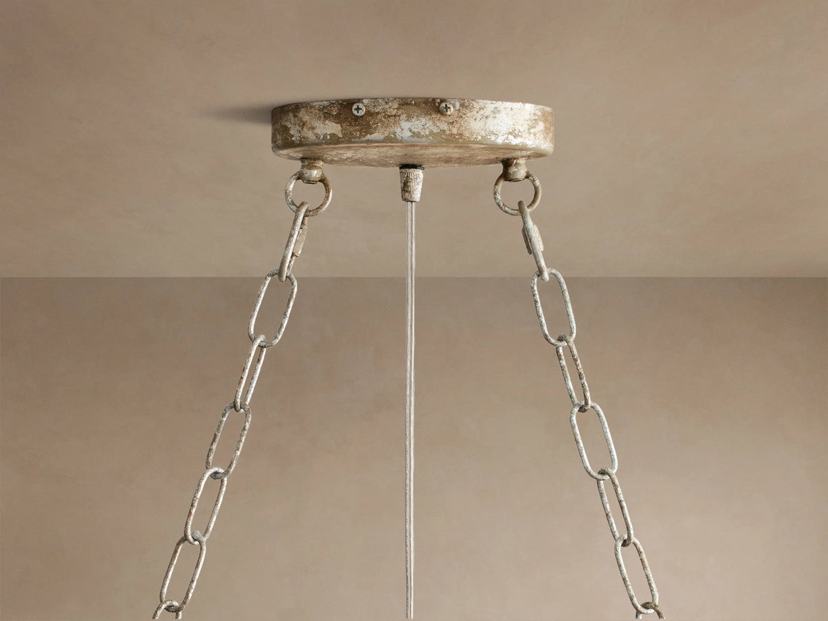 Fiore Oval Chandelier, silver with many sparkling clear crystal leaves, suspended by chains against a neutral background.