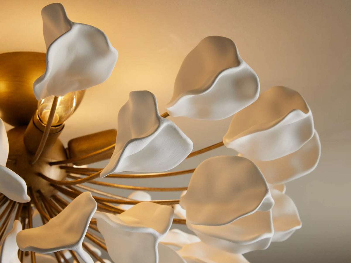 Lunaria Flush Mount with iron base and 56 white ceramic leaves fanning out, mounted on a beige ceiling.