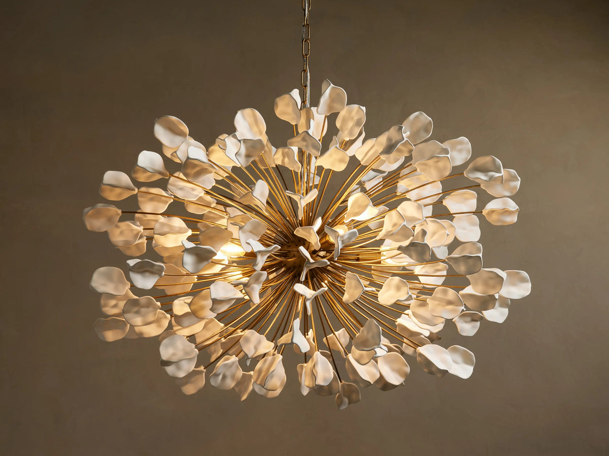 Lunaria Chandelier featuring a burst of 160 ceramic leaves in white and gold tones; warm light emitted from center bulbs.
