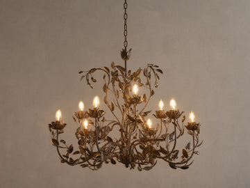 Nicoletta Round Chandelier, bronze metal with intricate leafy vines, 8 glowing candelabra bulbs, and dark crystal accents.