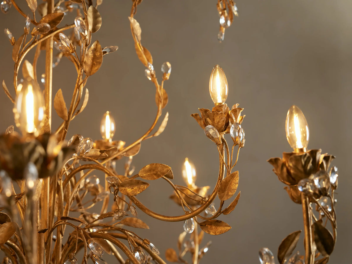 Nicoletta Round Chandelier: ornate gold brass with floral vines, clear crystal accents, and 12 lights.
