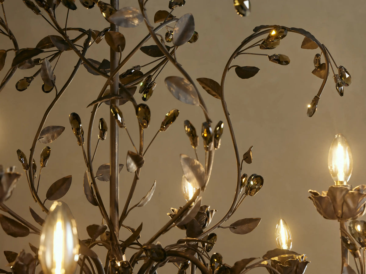 Close-up of Nicoletta Bronze Round Chandelier, featuring intricate dark metal branches, leaves, smoke crystals, and warm glowing bulbs.
