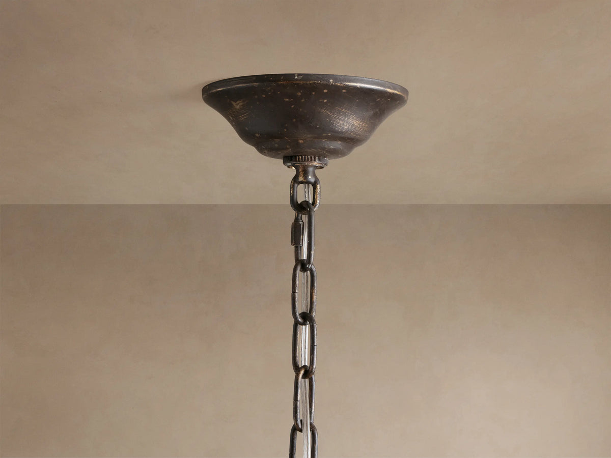 Nicoletta Round Chandelier close-up, showing bronze branches, leaves, smoke-colored crystals, and lit bulbs.