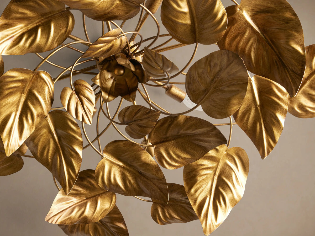 Ninfea Flush Mount, an ornate ceiling fixture with an antiqued gold finish, featuring numerous sculpted metal leaves around visible bulbs.