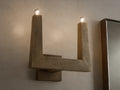 Front view of textured bronze U-shaped wall sconce with two glowing bulbs.