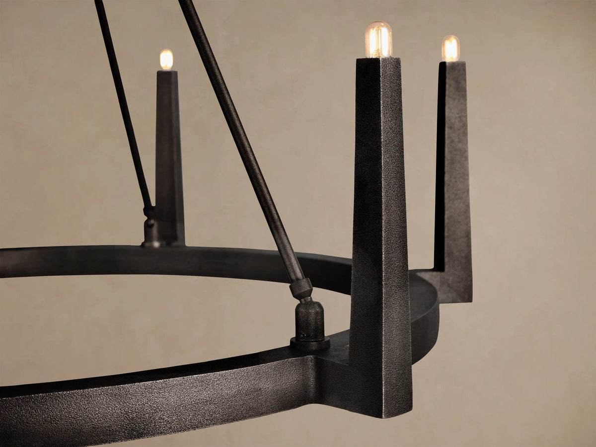 Emmet Round Chandelier, dark antiqued brass finish, hanging from ceiling, with 6 upward-facing candle-like lights.