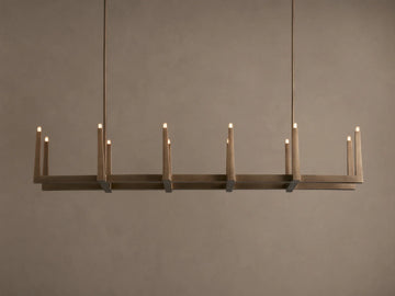 Emmet Linear Chandelier in antiqued brass, hanging horizontally. Rectangular frame features 10 lit, candelabra-style bulbs.