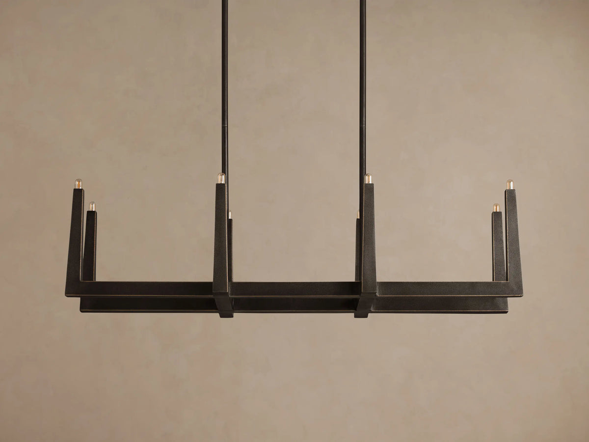 Emmet Linear Chandelier, dark antiqued brass, rectangular frame with upward-facing illuminated lights, hanging from rods.
