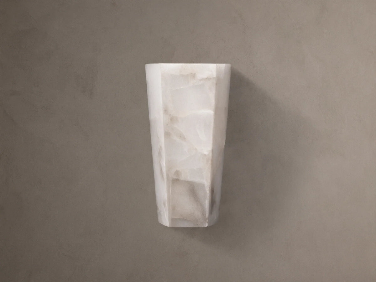 Alabaster Hexagonal Sconce. Vertical, off-white with natural cream and beige veining, on a neutral taupe wall.