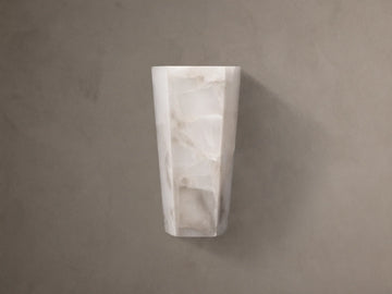 Alabaster Hexagonal Sconce. Vertical, off-white with natural cream and beige veining, on a neutral taupe wall.